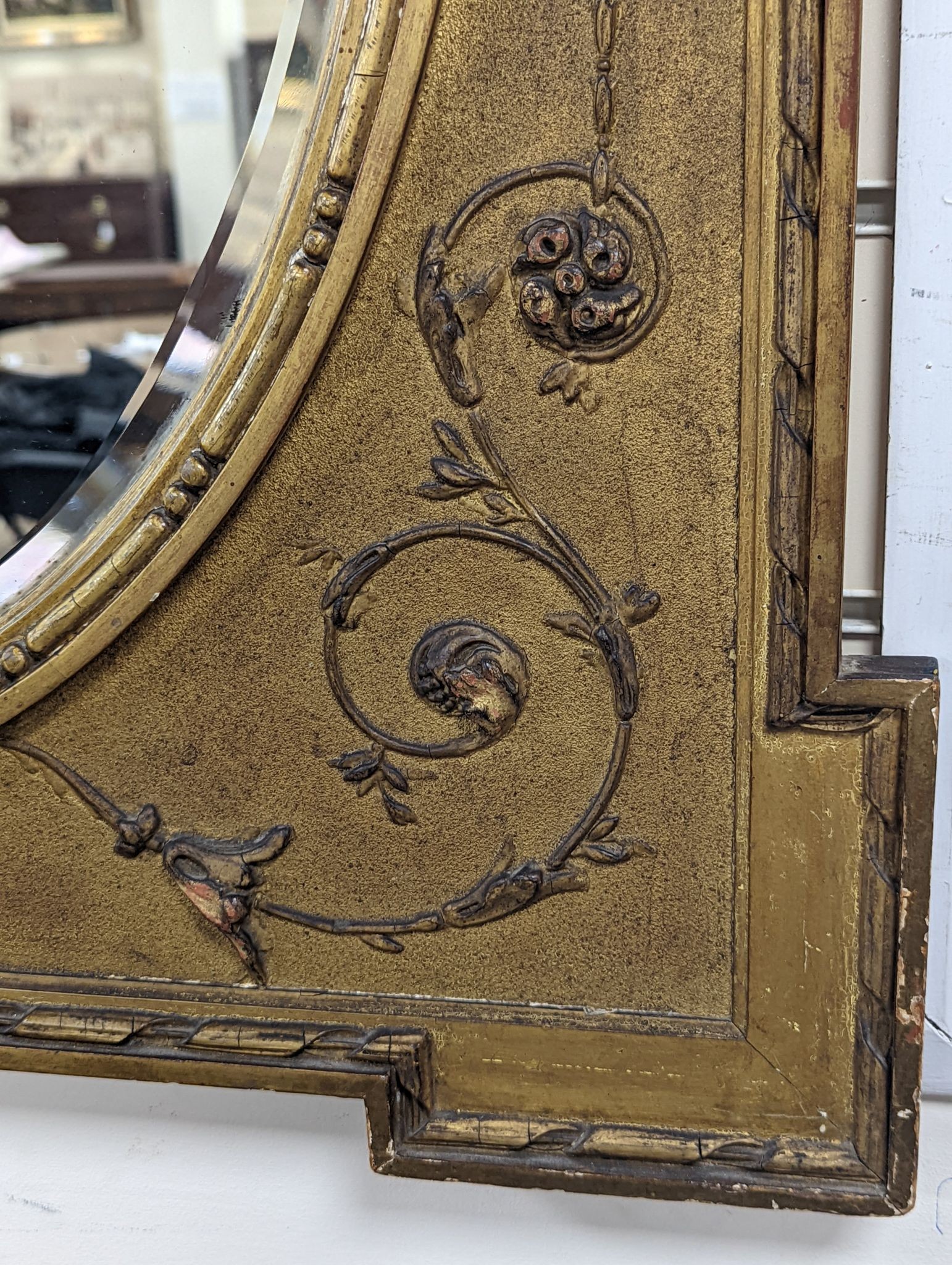 A Victorian style rectangular giltwood and gesso wall mirror, floral swag to top, with oval plate, width 70cm, height 92cm